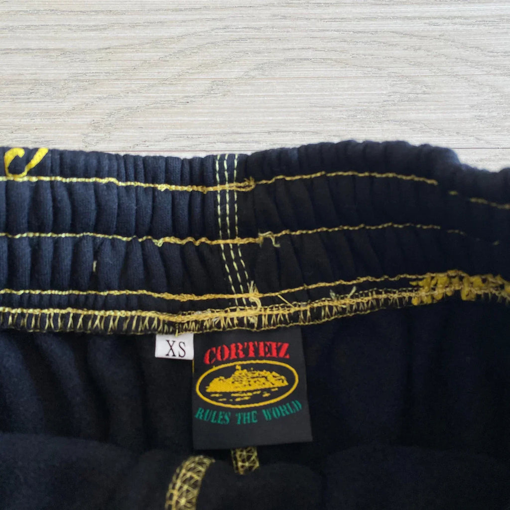 Corteiz All Over Print Joggers - Black/Yellow Ironleague